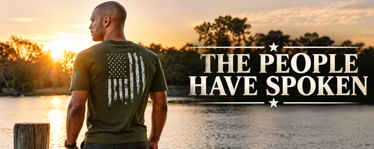 AOD model wearing an olive green patriotic T-shirt with a distressed American flag, overlooking a lake at sunset. Best Sellers collection banner.